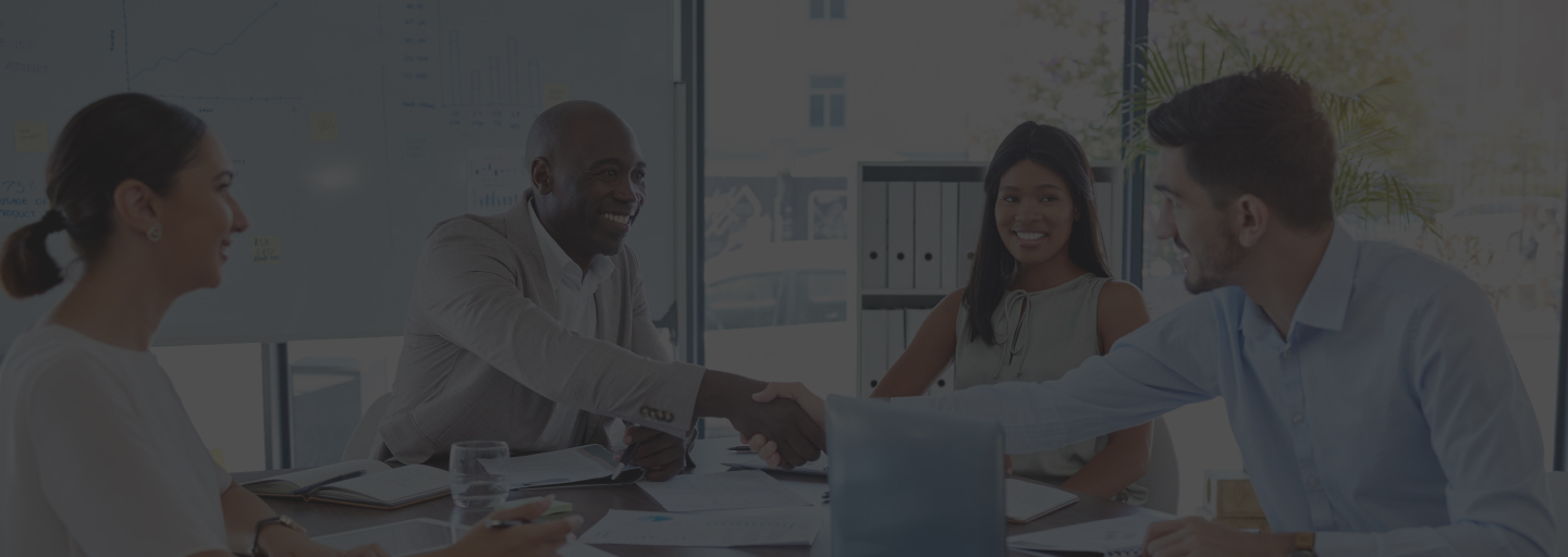 Diverse team members at Chiron LLC discussing Technology Consulting with Prospects in a boardroom